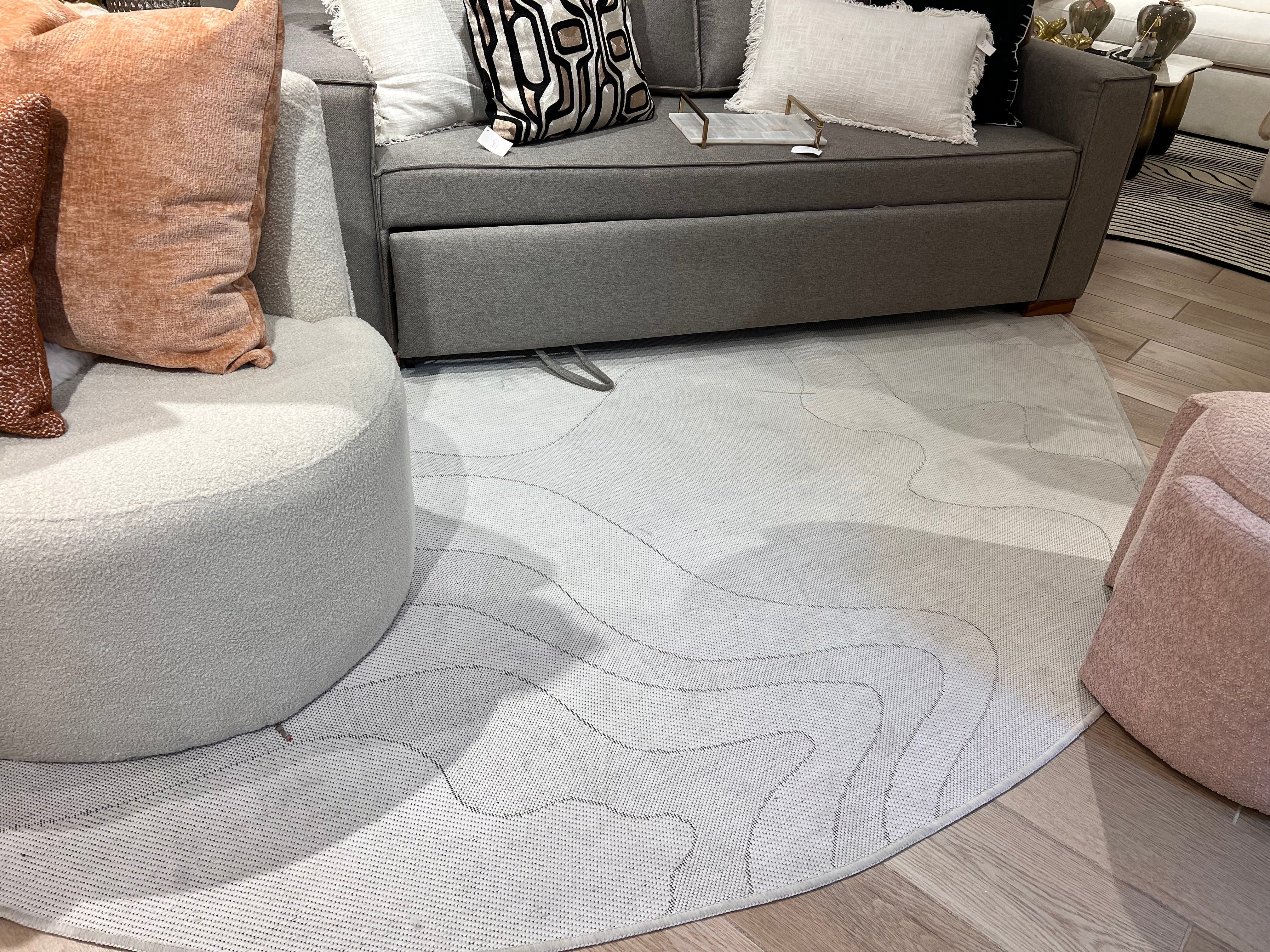 Ivory Indoor/Outdoor Rug with Organic Irregular Shape and Warm Mocha Accents.