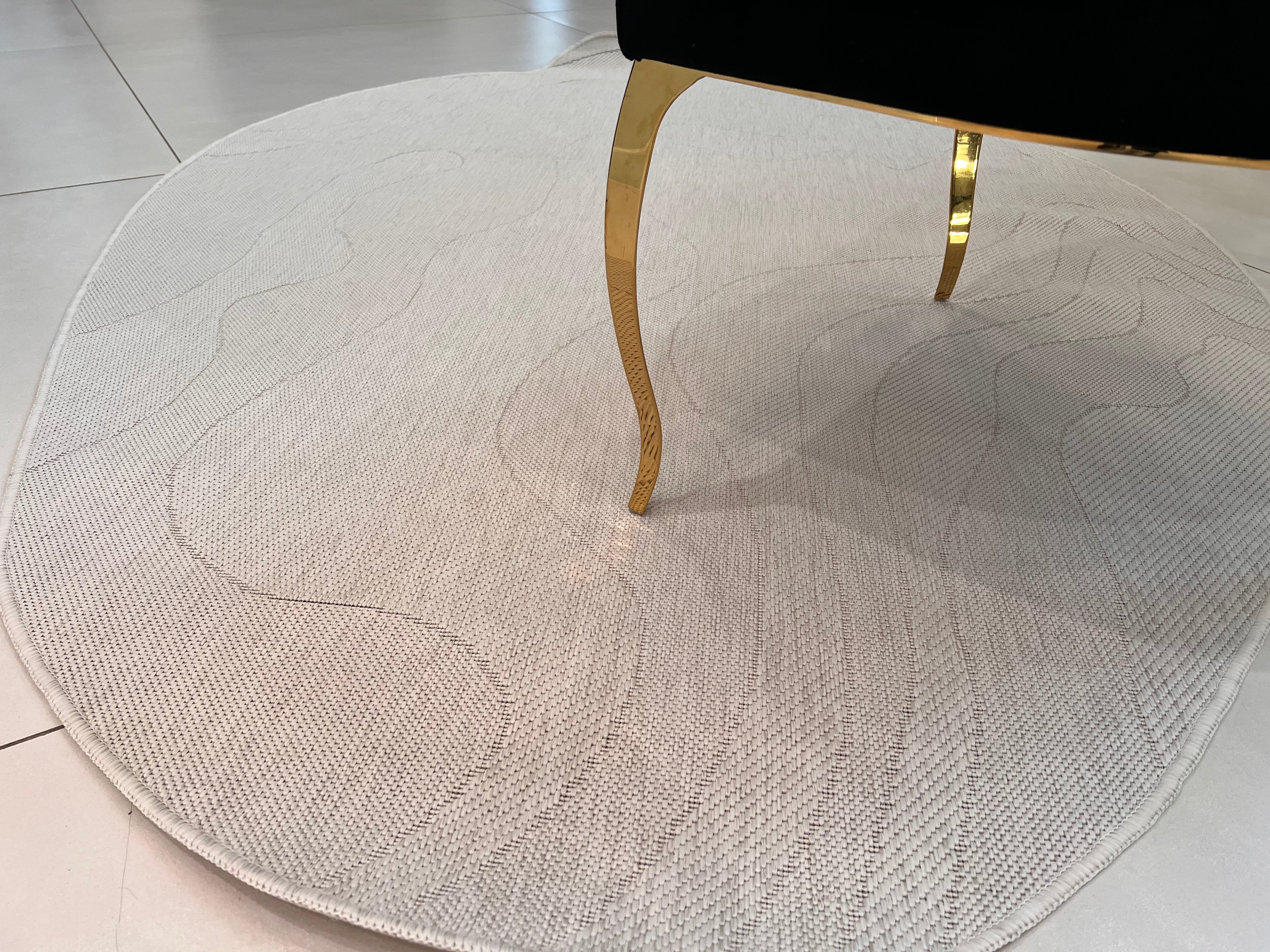 Ivory Indoor/Outdoor Rug with Organic Irregular Shape and Warm Mocha Accents.